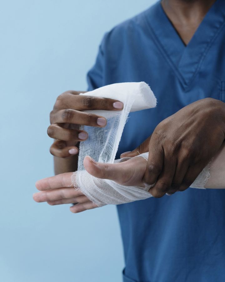 A clinician wrapping a patient’s hand